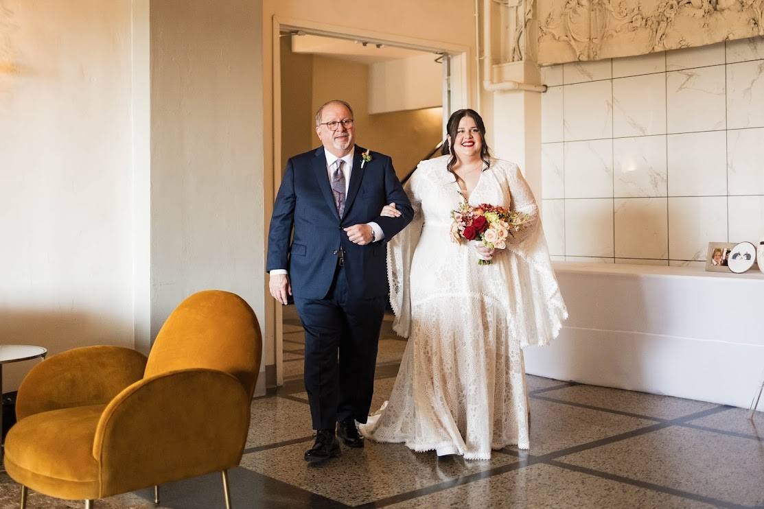 bride and her father walking on the isle on wedding day