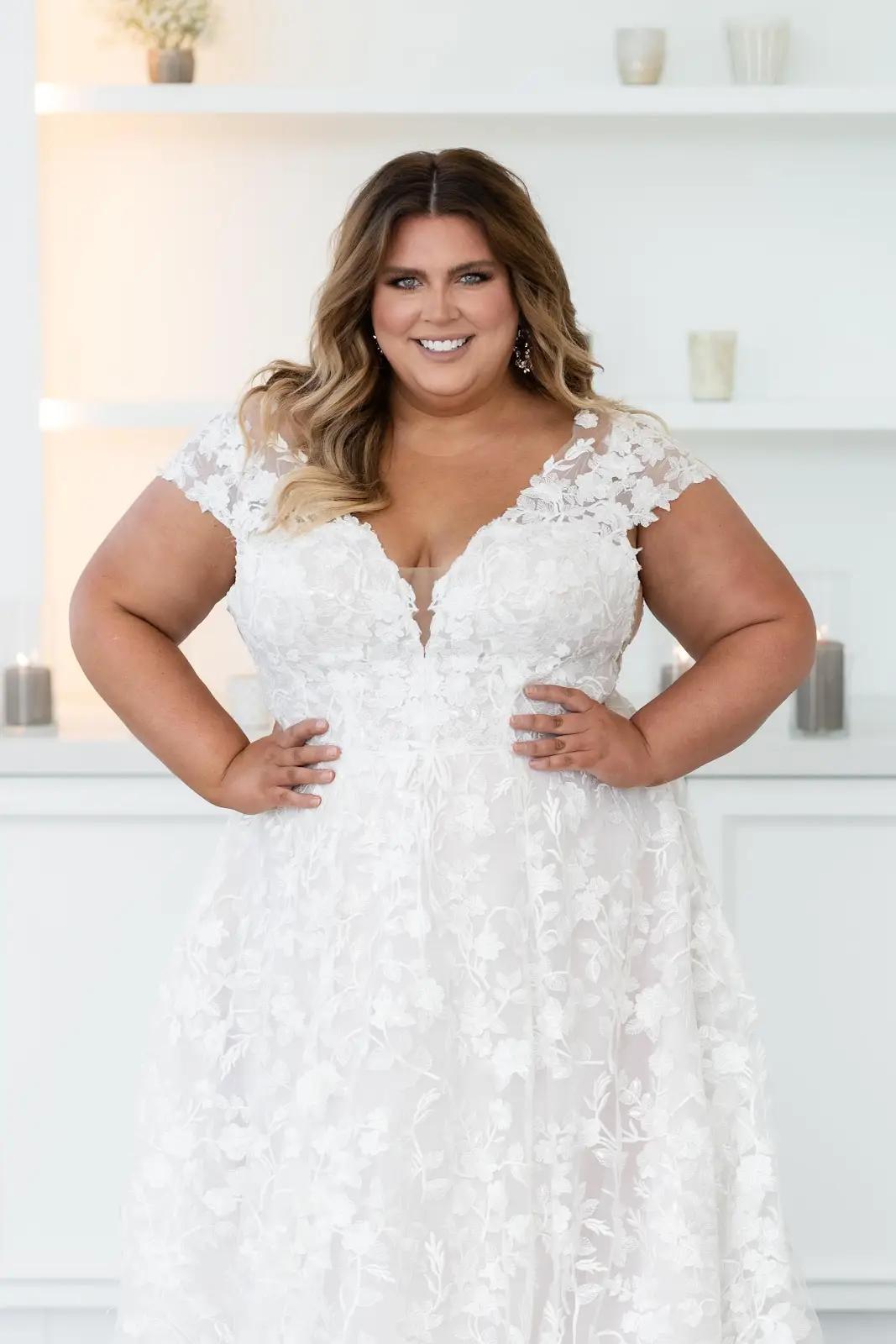 model wearing a plus size wedding dress